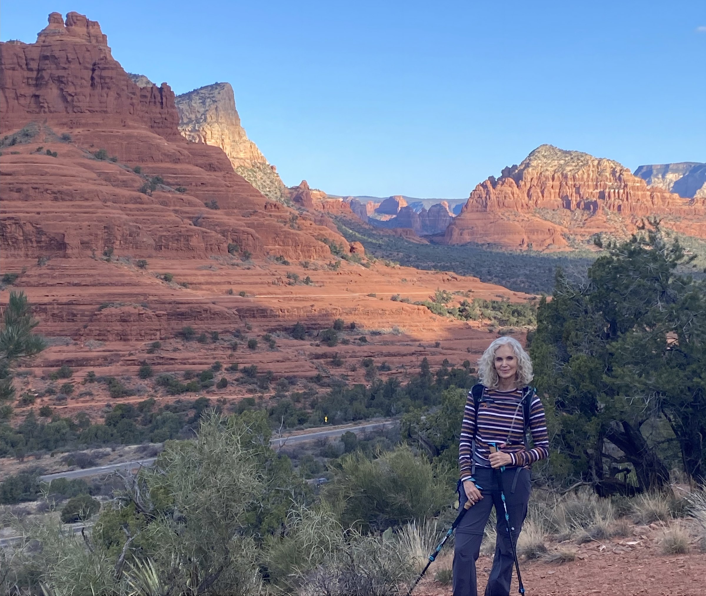 Ché Leone standing on a trail overlooking Sedona's red rock formations