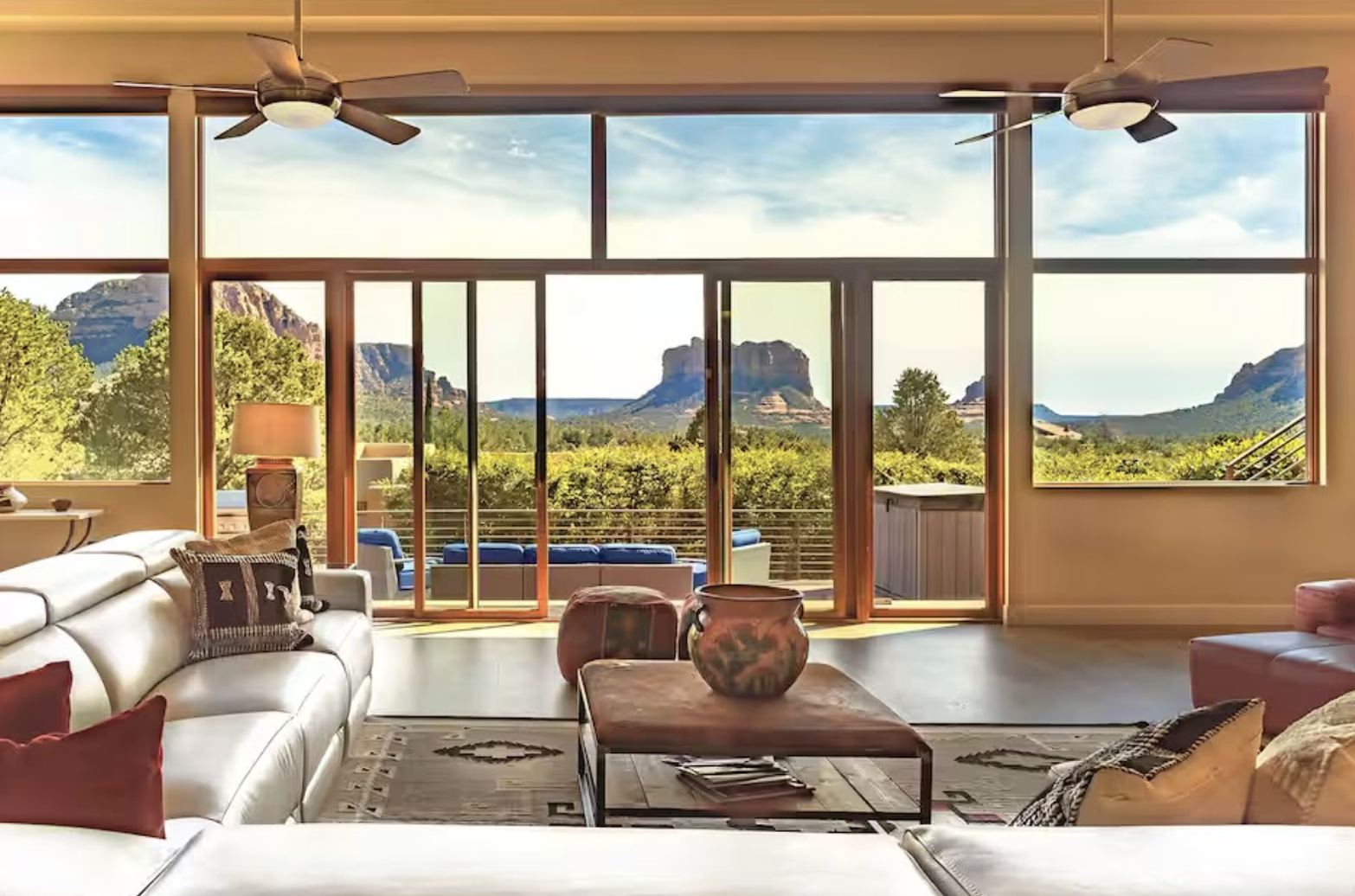 Living room of the retreat home with floor-to-ceiling windows overlooking Sedona's red rocks