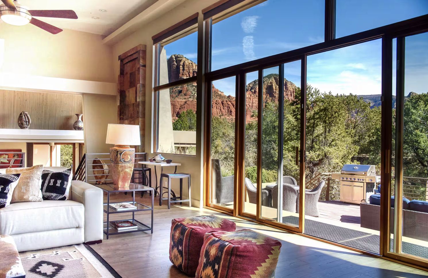 Sitting area with a view of red rock buttes through sliding glass doors